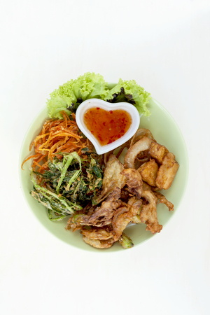 Deep fried mixed vegetables with thai chilli sauce on white wood backgroundの写真素材