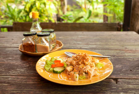 Thai style fried noodle on wooden tableの写真素材