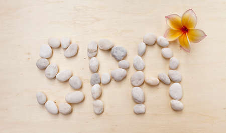 Spa stone text on wood background with flowerの写真素材