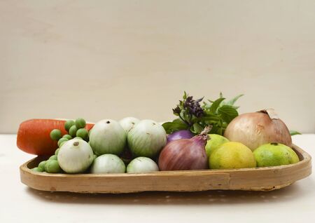 Fresh vegetables basket with space on wood backgroundの写真素材