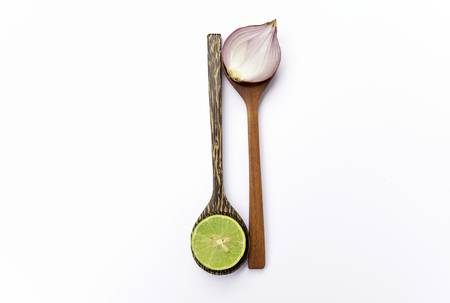 Fresh thai lime and red onion on wooden spoonの写真素材
