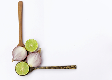 Fresh thai lime and red onion on wooden spoon frameの写真素材