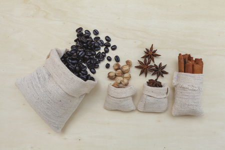 Coffee beans and spices on wood backgroundの写真素材
