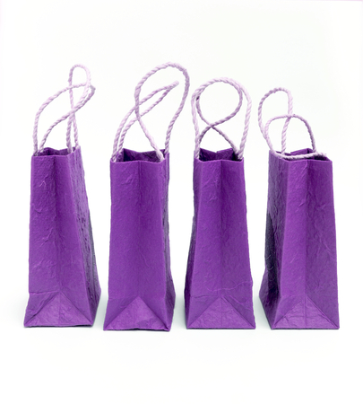 Purple paper shopping bag on white backgroundの写真素材