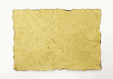 Burnt edges yellow tone natural texture paper on white backgroundの写真素材