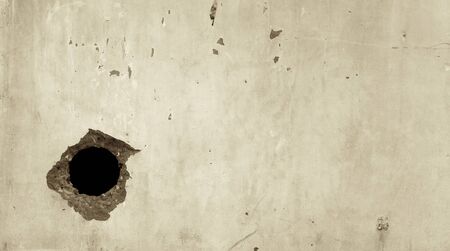 Vintage tone Hole on the cement wallの写真素材