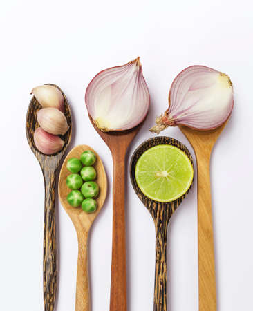 Vegetable on wooden spoon on white background vertical styleの写真素材