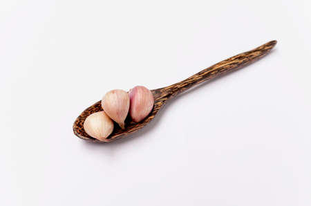Fresh garlic on wooden spoonの写真素材
