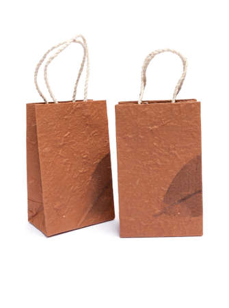 Brown shopping bag with leaf pattern on white backgroundの写真素材