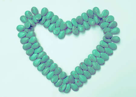 Vintage tone Green stone design pattern in a heart shape on white background