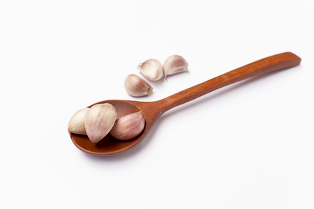 Garlic on wooden spoonの写真素材