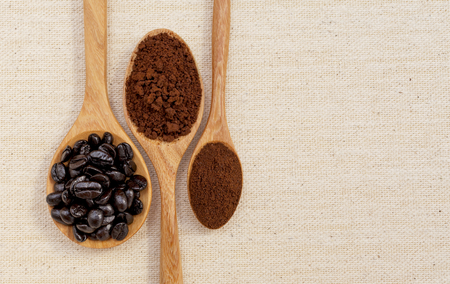 Closeup Cofee beans and coffee powder in wooden spoon background horizontal styleの写真素材