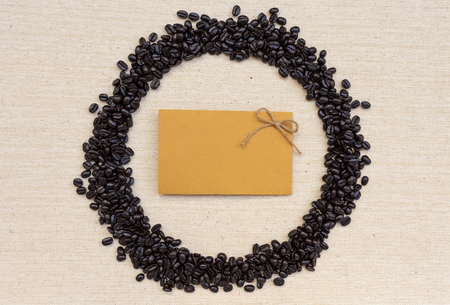 Yellow card in round coffee beans frameの写真素材