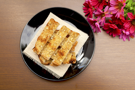Herbs garlic bread on wood background with flowerの写真素材
