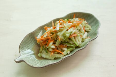 Spicy cucumber salad on wooden tableの写真素材