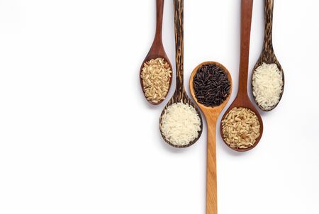 Wooden spoon set with organic rice on white backgroundの写真素材