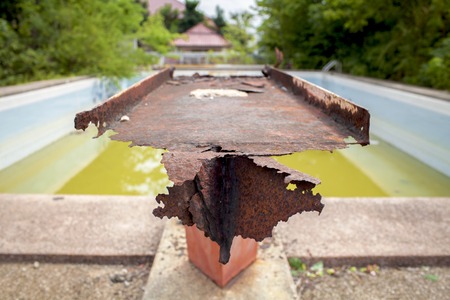 Rusty steel with old swimming pool backgroundの写真素材