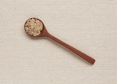 Brown rice in wooden spoonの写真素材