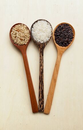 Rice spoon on wood background vertical styleの写真素材
