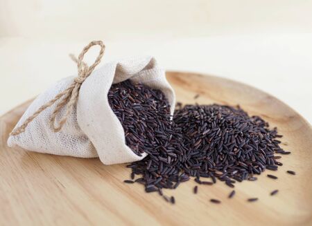 Closeup black rice on wooden trayの写真素材