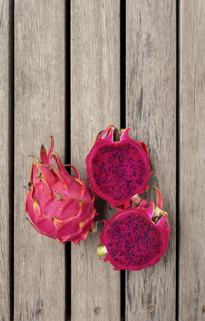 Red Dragon fruit with space on wooden floor vertical styleの写真素材