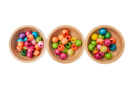 Colorful wooden beads in wooden bowlの写真素材