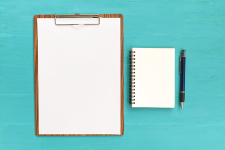 Blank paper and notebook on blue backgroundの写真素材