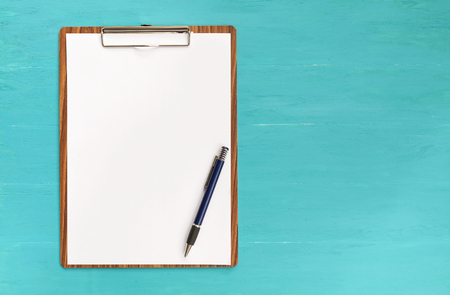 Wooden clipboard with space on blue backgroundの写真素材