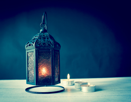 Metal lantern with candle with dark background, Vintage cool tone styleの写真素材