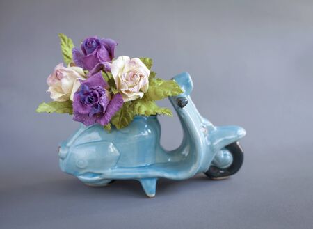 Purple roses on blue scooter, flower deliveryの写真素材