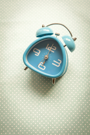 Blue clock on vintage style backgroundの写真素材