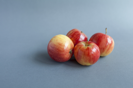 Fresh red mini apples on grey backgroundの写真素材