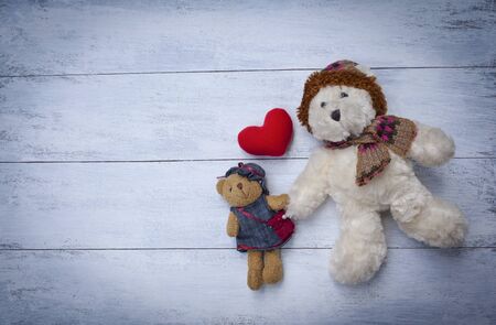 Teddy bear friend with red heart on white table backgroundの写真素材