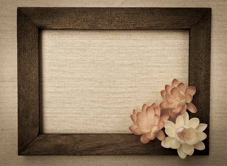 Vintage tone style wooden frame with flowers on canvas backgroundの写真素材