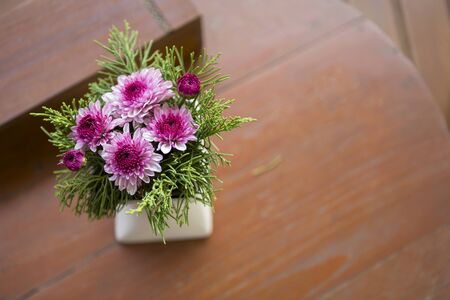 Pink flower vase with space on wooden coffee tableの写真素材