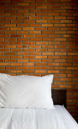 Bed and red brick wall backgroundの写真素材