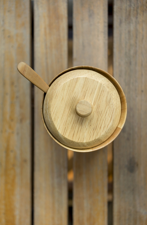 Wooden sugar bow on wood background vertical styleの写真素材