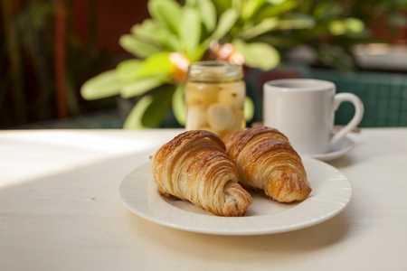 French croissant with coffee in the gardenの写真素材