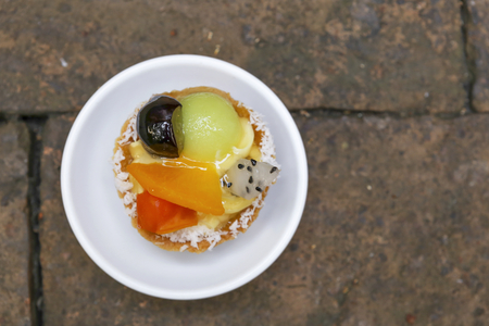 Fruit tart on brick wall backgroundの写真素材