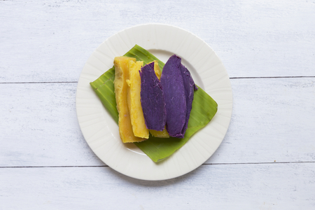 Healthy steamed sweet potato on white wooden backgroundの写真素材