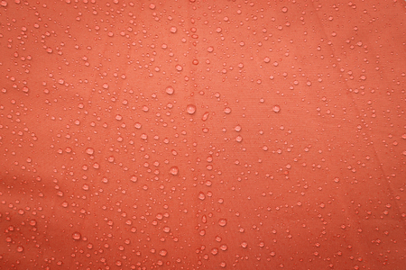 Water drops on red umbrella backgroundの写真素材