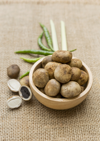 Fresh Barometer Earthstars in wooden bow and lemongrass, green chili on hessian backgroundの写真素材