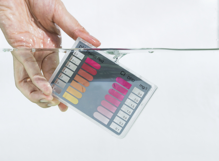 Water test kit dipping in water with white backgroundの写真素材