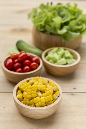Vegetables in wooden bowl, healthy salad, diet foodの写真素材