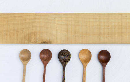 Wooden spoon with natural pattern with blank wooden sign on white backgroundの写真素材