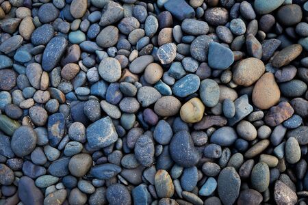 Stone with different sizes and color from the beach background