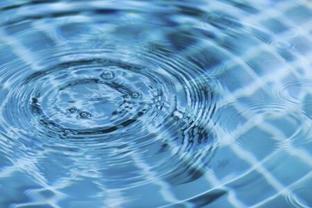 Blurry water drop on blue swimming pool water surface, Abstract water backgroundの写真素材