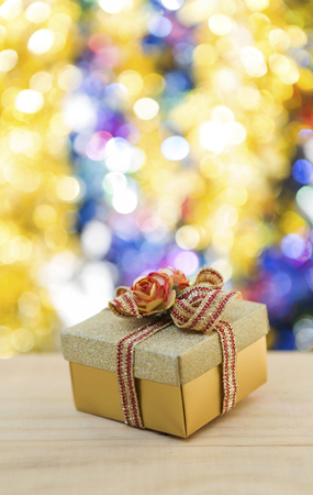 Christmas gift box with colourful bokeh backgroundの写真素材