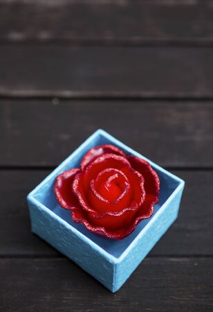 Red candle rose flower in blue paper box, valentine conceptの写真素材