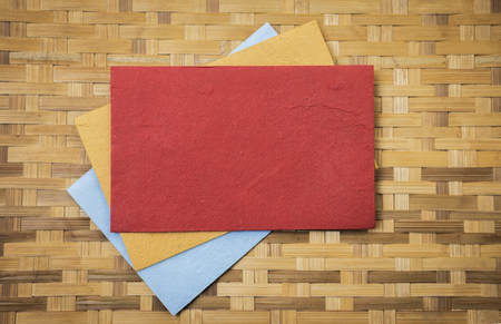 Colorful paper card on bamboo pattern texture background